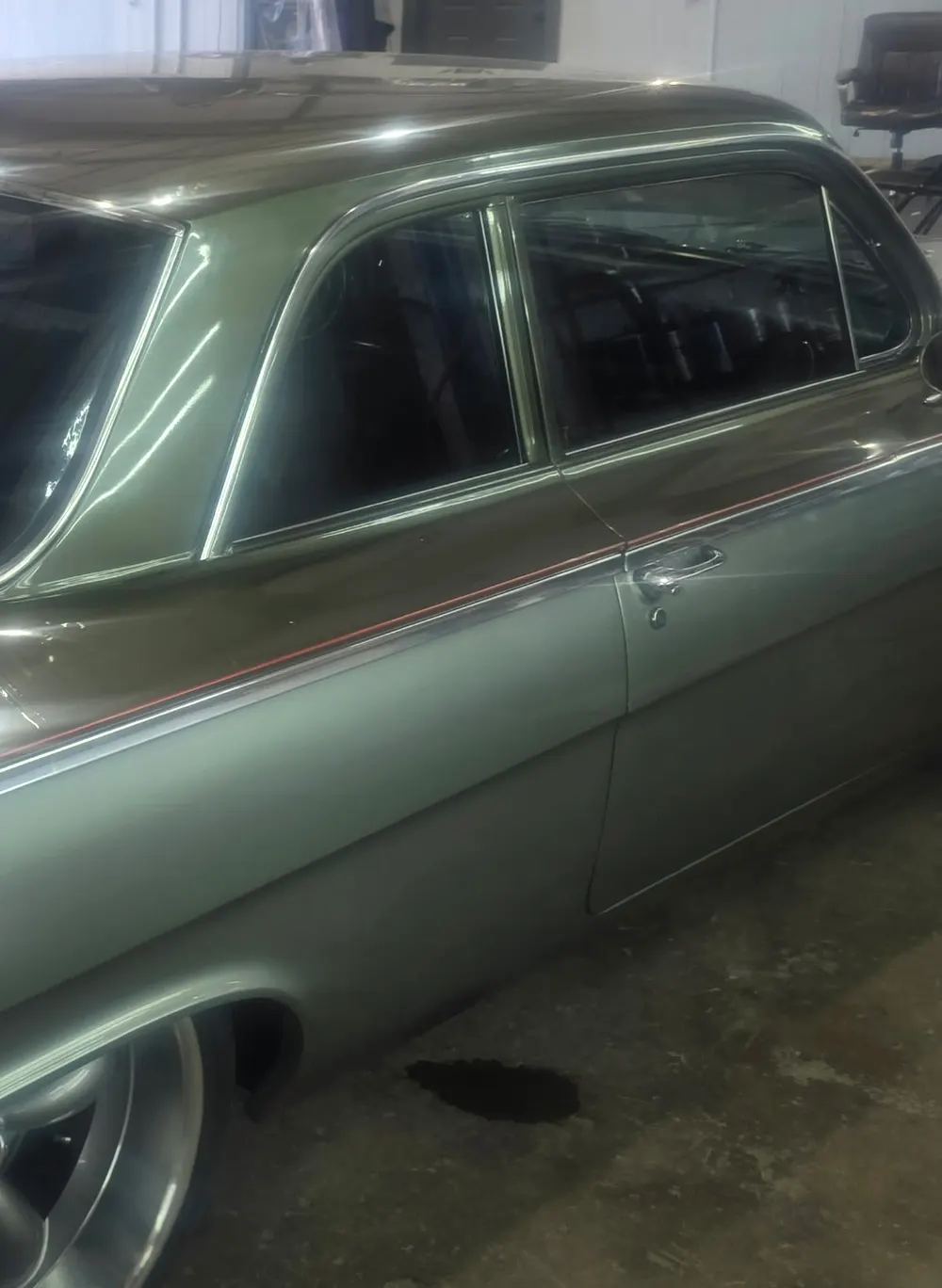Side glass of a green early 1960s Chevrolet hardtop, freshly tinted dark